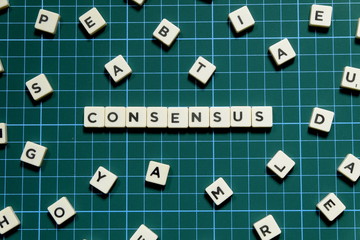 Consensus word made of square letter block on green square mat background.