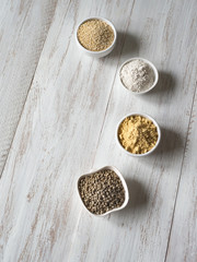 Superfoods in plates on a white table.