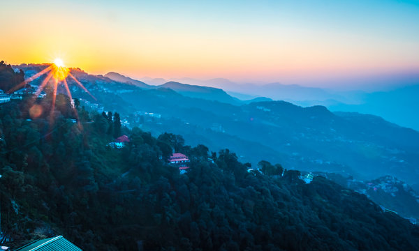 sunrise forming winter line in mussoorie India . layers of mountains top view