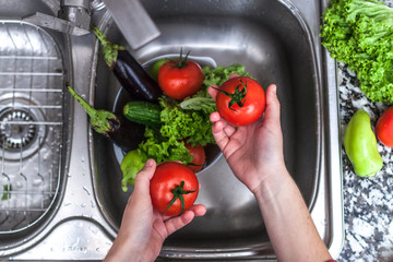 Washing vegetables for cooking fresh salad. Healthy food.