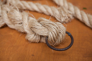 Coil of rope with a marine unit, and an iron ring.