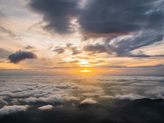 Fototapeta na wymiar Beautiful Sunrise Sky with Sea of the mist of fog in the morning on Khao Luang mountain in Ramkhamhaeng National Park,Sukhothai province Thailand