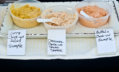 Top view, medium distance of three variations of chicken salad as samples and for sale at a...