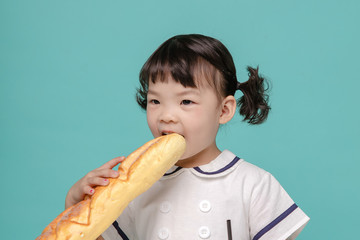Little pretty Asian girl laughing portrait with milk and bread, healthy and happy lifestyle.