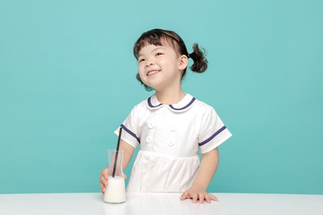 Little pretty Asian girl laughing portrait with milk and bread, healthy and happy lifestyle.