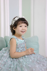 Little pretty Asian girl dressing as princess laughing portrait, healthy and happy lifestyle.