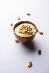 Sweet Rabdi or Lachha Rabri or basundi, made with pure milk garnished with dry fruits. Served in a bowl over moody background. Selective focus