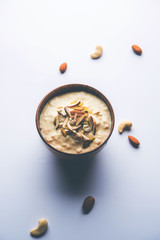 Sweet Rabdi or Lachha Rabri or basundi, made with pure milk garnished with dry fruits. Served in a bowl over moody background. Selective focus