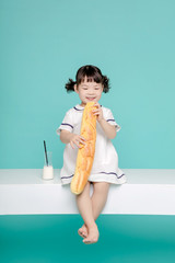 Little pretty Asian girl laughing portrait with milk and bread, healthy and happy lifestyle.