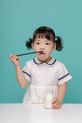 Little pretty Asian girl laughing portrait with milk and bread, healthy and happy lifestyle.