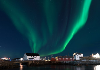 Fisherman village with Aurora in the background travel concept world explore northern light / Lofoten Norway