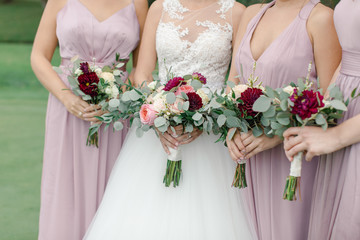 wedding bouquet in hands of the bride and bridesmaids