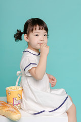 Little pretty Asian girl laughing portrait with milk and bread, healthy and happy lifestyle.