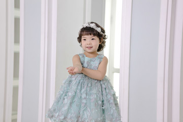 Little pretty Asian girl dressing as princess laughing portrait, healthy and happy lifestyle.