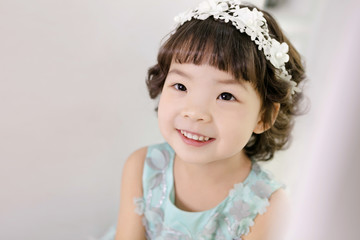 Little pretty Asian girl dressing as princess laughing portrait, healthy and happy lifestyle..