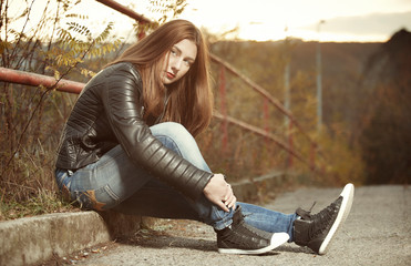 Fototapeta premium Pretty brunette young woman posing in autumn late sun