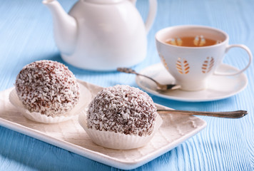 Tasty cocoa and chocolate cakes and cup of tea.