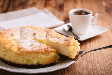 Homemade vanilla cheesecake and cup of coffee.