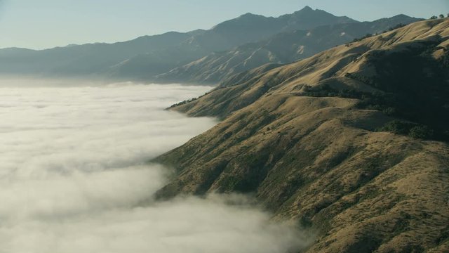Aerial view sunshine over foggy mountains Big Sur