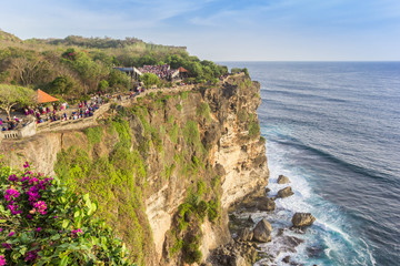 Fototapeta na wymiar People walking on the edge of the cliffs at Ulu Watu, Bali, Indonesia