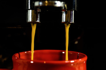 coffee pouring from a coffee machine close up