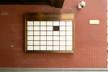 Light box advertisement on red brick wall..