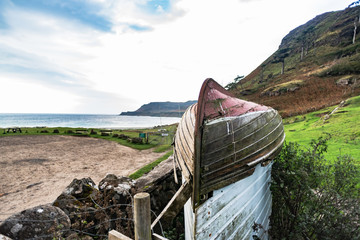 upside down boat as a roof for the shed, on the beach, Isle of Mull.