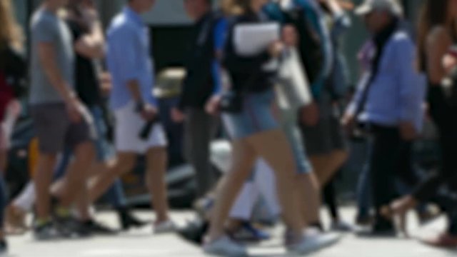 Side view blurry pedestrians walking.
People crossing a street in the city of Barcelona.
