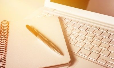 Laptop with notebook and pen. Isolated  background