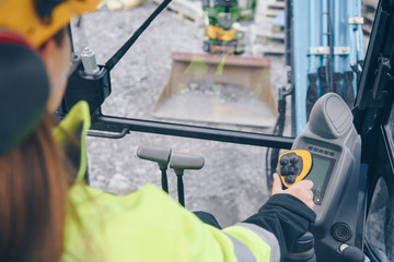 low angle view of Woman driving heavy equipment