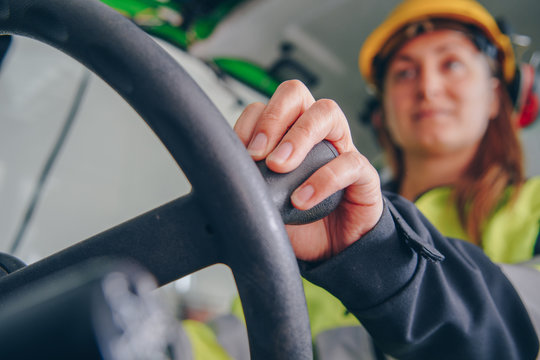 Close up portrait of woman operating front end loader heavy equipment