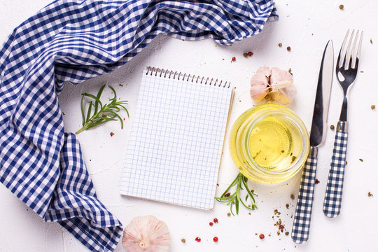 Empty notebook for recipes with fresh herbs and spices