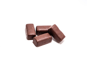 Chocolate candies on white background close up