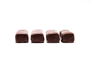 Chocolate candies on white background close up