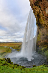 Fototapeta na wymiar Majestic Seljalandsfoss; the most famous waterfall in Iceland. Sunset landscape. Beautiful tourist attraction in one of the main holiday destinations.