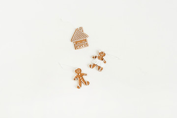 Gingerbread man, woman and house cookies isolated on white background. Flat lay, top view Christmas / New Year food concept.