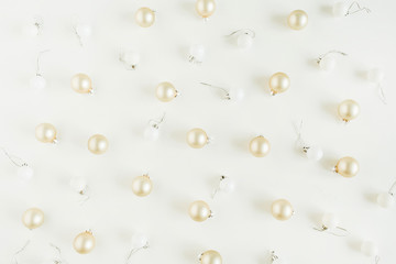 Golden Christmas balls decorations on white background. Flat lay, top view Christmas / New Year holiday composition.