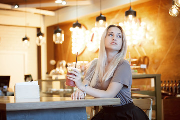 Beautiful Young Woman with Fruit smoothie