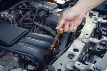 Car mechanic working with wrench in garage. Repair service.