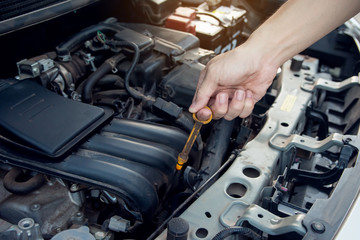 Car mechanic working with wrench in garage. Repair service.