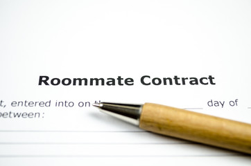Roommate contract with wooden pen