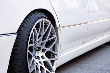 Fototapeta na wymiar Close-up of the white stanced car wheel