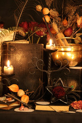 Black candle Magic Ritual. Antique Magic Book. Witchcraft  Peacock feathers and candle background.