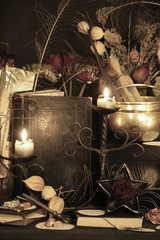 Black candle Magic Ritual. Antique Magic Book. Witchcraft  Peacock feathers and candle background.