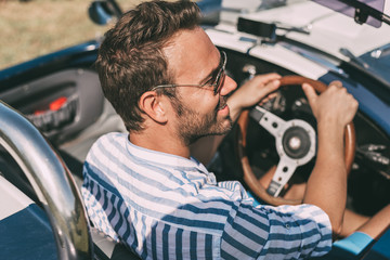 Man driving a convertible vintage car