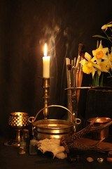 Antique Magic Book. Witchcraft Peacock feathers and candle background. Black candle Magic Ritual.