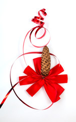 red bow with fir cone on white background