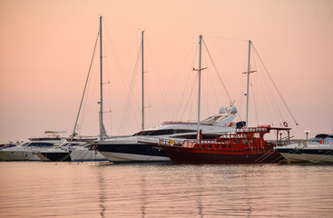 Pink sunset on the sea lights yachts