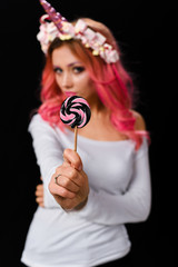 The Unicorn Girl. Young beautiful girl in the image of unicorn with pink hair and stylish make-up, copy space.