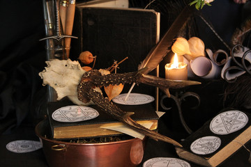 Black candle Magic Ritual. Antique Magic Book. Witchcraft  Peacock feathers and candle background.